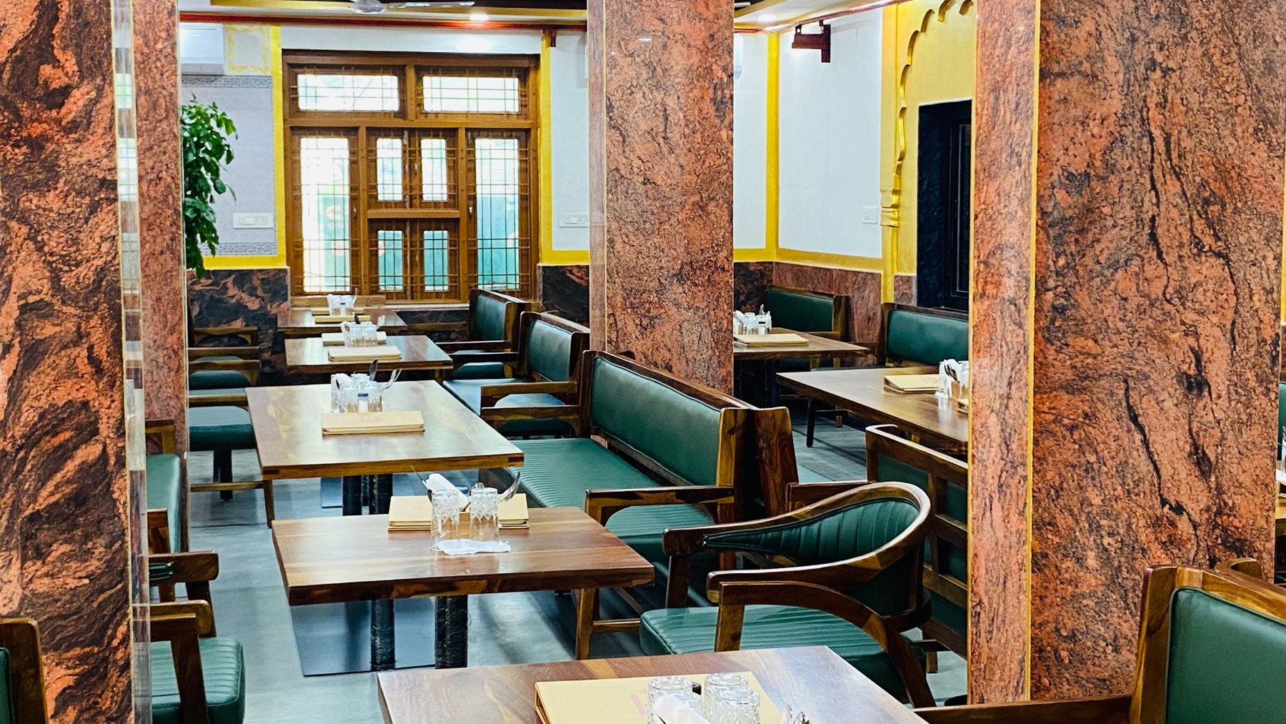 Restaurant seating with green upholstered benches